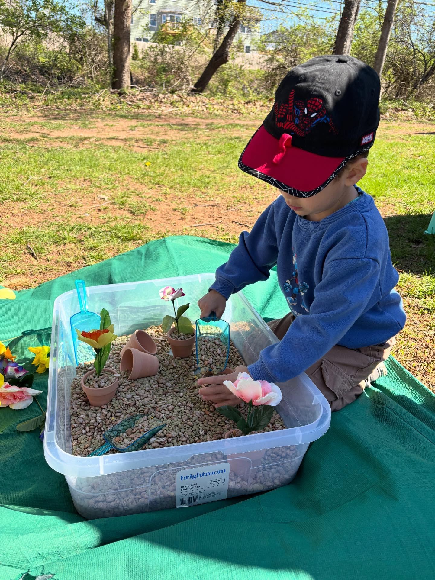 Outdoor sensory bin with flowers and beans