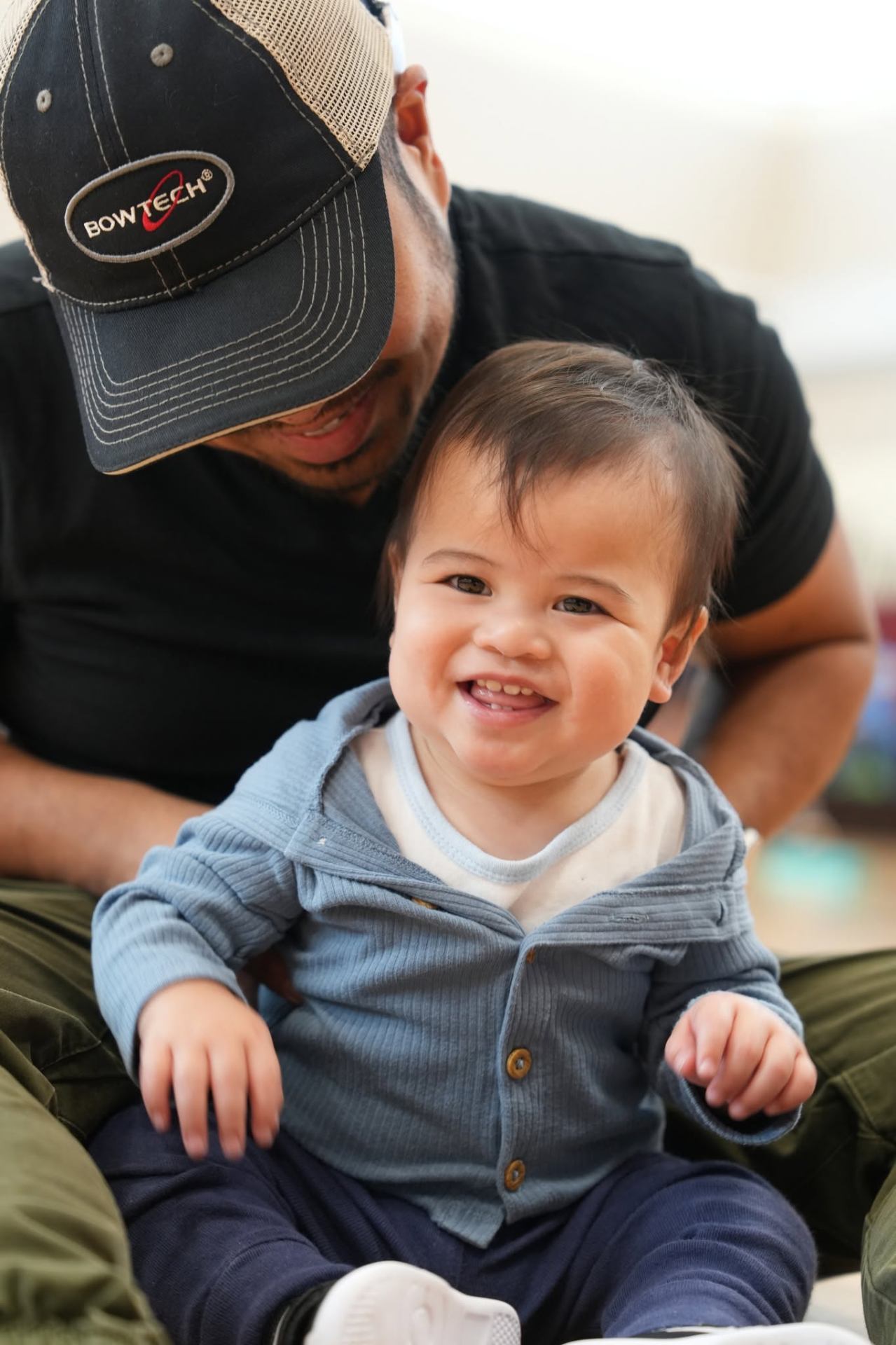 Toddler smiling with a parent