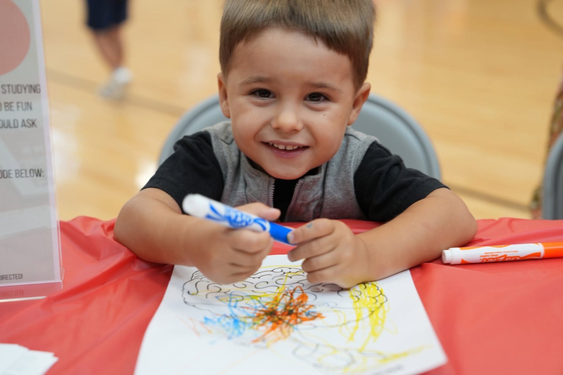 Young artist coloring at the art table